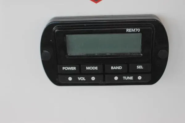 Slide: The Image of 2023 Scarab 255 ID boat control panel with REM70 display and buttons. - 13