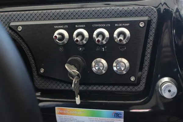 Slide: The Image of Control panel of a 2023 Scarab 255 ID boat with switches and ignition key. - 7
