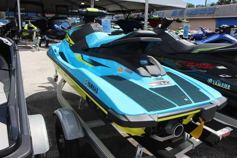 Slide: The Image of 2023 Yamaha WaveRunner EX Deluxe in blue on a trailer. - 2
