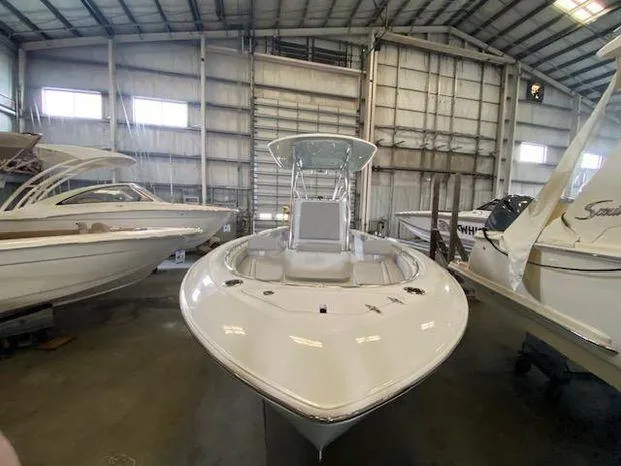 Slide: The Image of 2024 Contender 24 Sportfish boat in a storage facility. - 2
