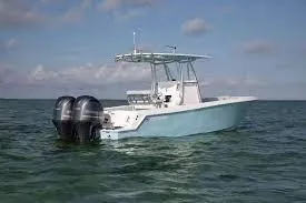 Slide: The Image of 2024 Contender 24 Sportfish boat with twin outboard motors on open water. - 3