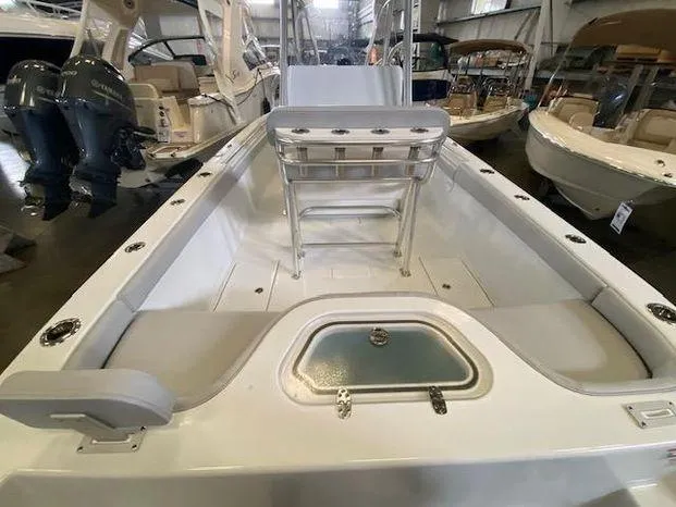 Slide: The Image of 2024 Contender 24 Sportfish boat interior with seating and storage compartments. - 5