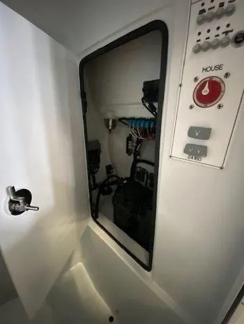 Slide: The Image of 2024 Contender 24 Sportfish electrical panel and wiring compartment. - 6