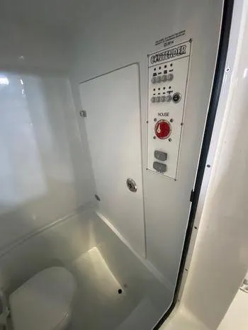 Slide: The Image of 2024 Contender 24 Sportfish boat interior control panel and toilet. - 7