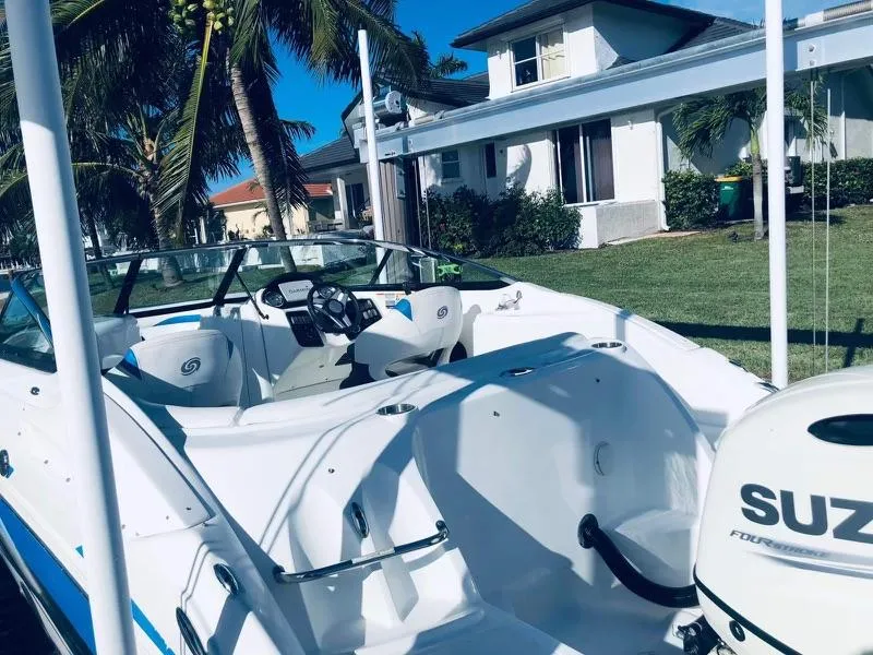 Slide: The Image of 2019 Godfrey Hurricane SD2200 boat with Suzuki outboard motor in a residential area. - 10