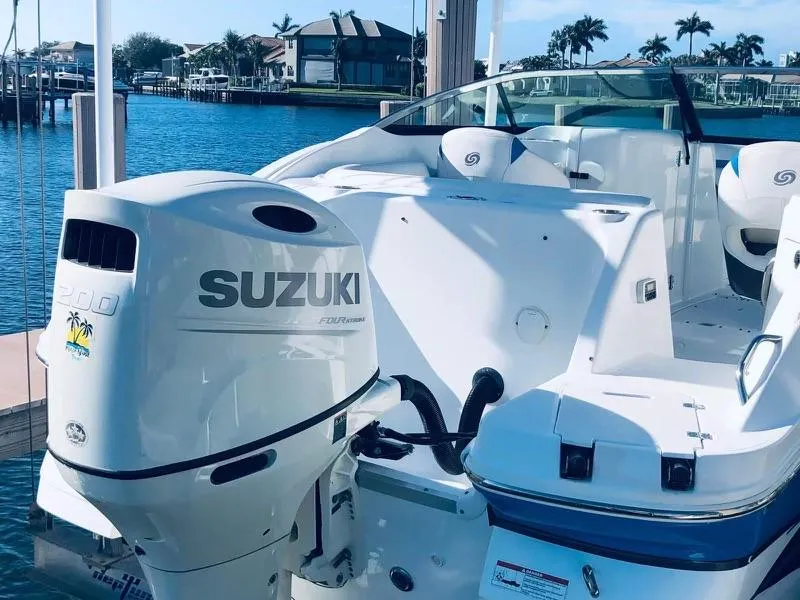 Slide: The Image of 2019 Godfrey Hurricane SD2200 boat with Suzuki outboard motor docked by waterfront homes. - 13