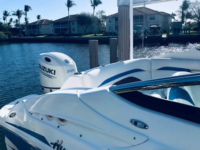 Slide: The Image of 2019 Godfrey Hurricane SD2200 boat with Suzuki 200 outboard motor docked by waterfront homes. - 14