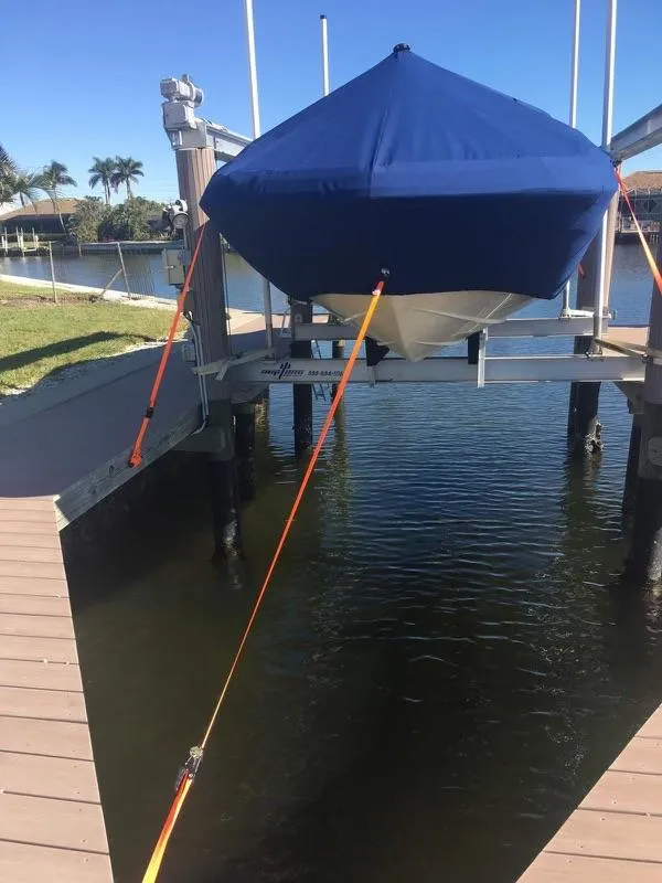 Slide: The Image of 2019 Godfrey Hurricane SD2200 boat on a lift with blue cover. - 15