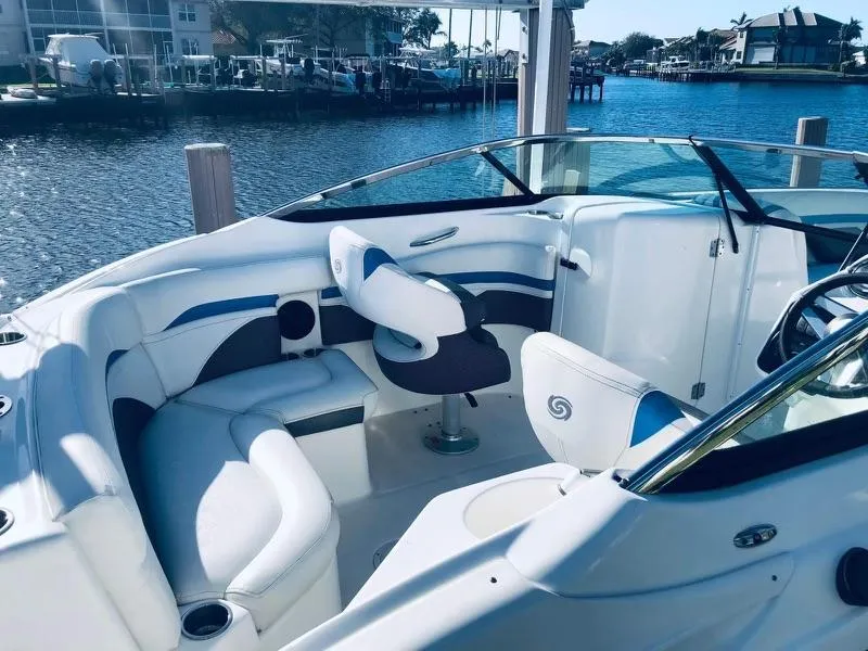 Slide: The Image of 2019 Godfrey Hurricane SD2200 boat interior with white seating, docked by the water. - 7