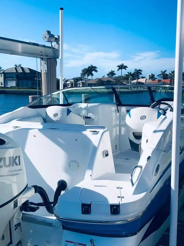 Slide: The Image of 2019 Godfrey Hurricane SD2200 boat docked by waterfront homes. - 9
