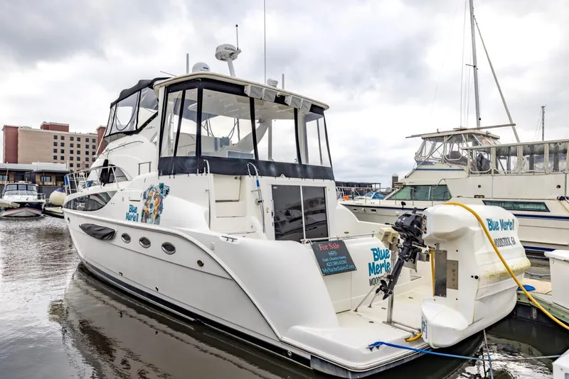 Slide: The Image of 2004 Meridian 459 Motoryacht docked in marina, featuring sleek design and spacious deck. - 1