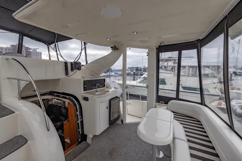 Slide: The Image of Interior of 2004 Meridian 459 Motoryacht with seating and kitchenette, docked at marina. - 11