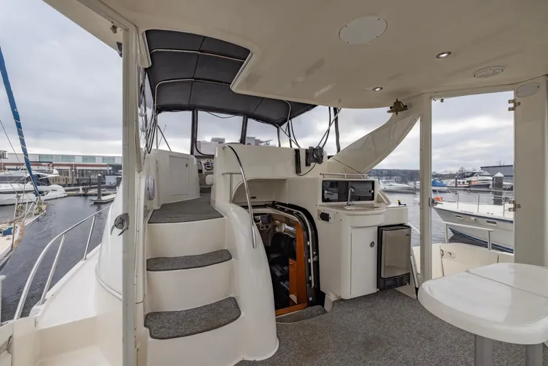 Slide: The Image of 2004 Meridian 459 Motoryacht interior with helm, seating, and marina view. - 12