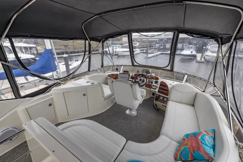 Slide: The Image of 2004 Meridian 459 Motoryacht interior with helm, seating, and marina view. - 15