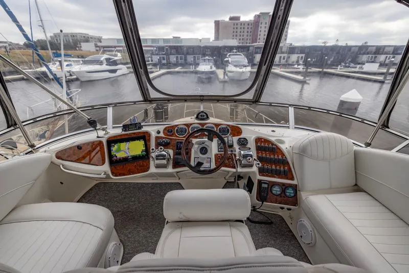 Slide: The Image of 2004 Meridian 459 Motoryacht helm with marina view, featuring modern navigation equipment and luxurious seating. - 17