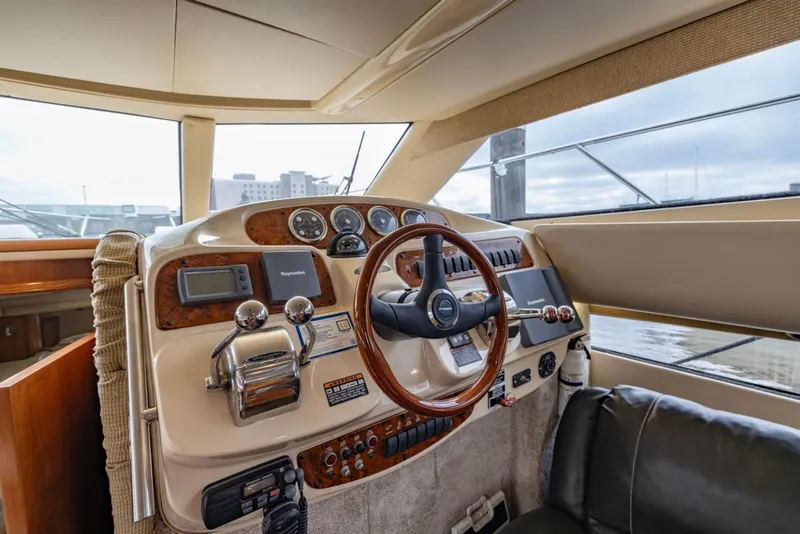 Slide: The Image of Interior helm of 2004 Meridian 459 Motoryacht with steering wheel and control panel. - 26