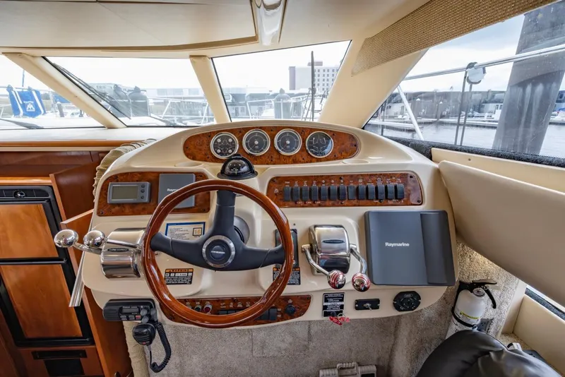 Slide: The Image of 2004 Meridian 459 Motoryacht helm with wood accents and modern navigation instruments. - 27