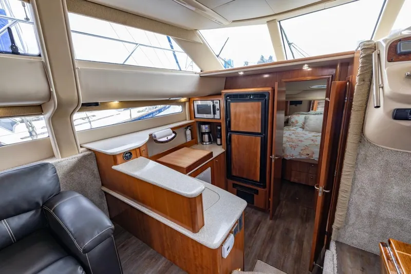 Slide: The Image of 2004 Meridian 459 Motoryacht interior with kitchen and cozy cabin view. - 29
