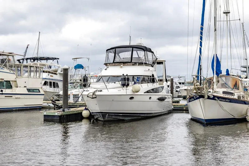 Slide: The Image of 2004 Meridian 459 Motoryacht docked at a marina, surrounded by other boats. - 3