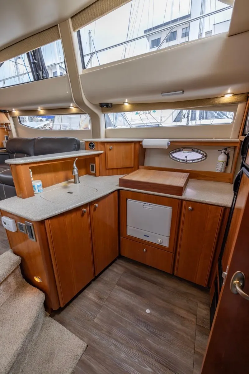 Slide: The Image of Interior of 2004 Meridian 459 Motoryacht with modern kitchen and wooden cabinetry. - 30