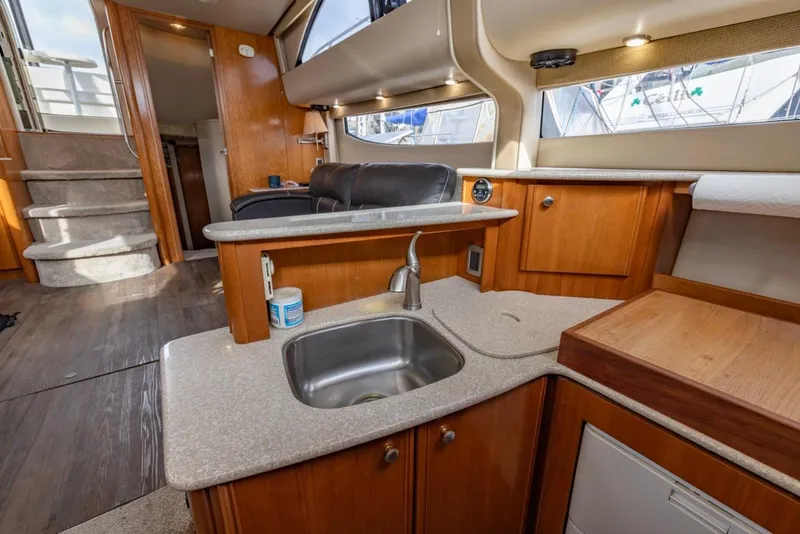 Slide: The Image of Interior of 2004 Meridian 459 Motoryacht with kitchen sink and wooden cabinetry. - 32