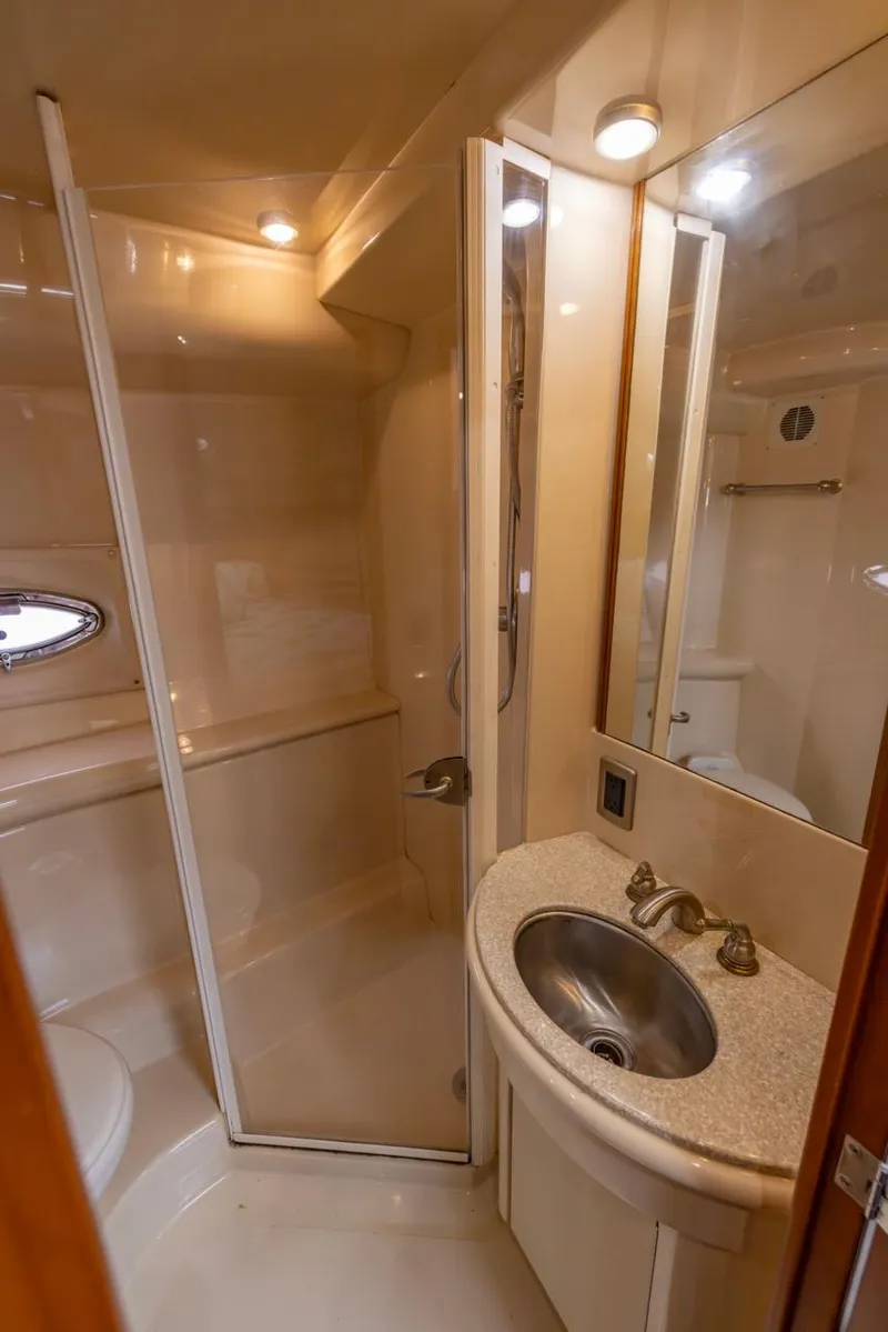 Slide: The Image of 2004 Meridian 459 Motoryacht bathroom with shower, sink, and mirror. - 33