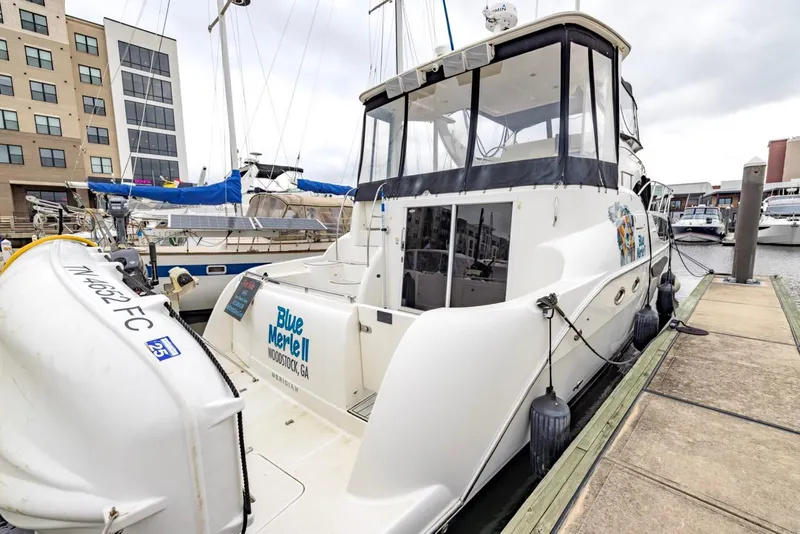 Slide: The Image of 2004 Meridian 459 Motoryacht docked at marina, featuring spacious deck and modern design. - 4