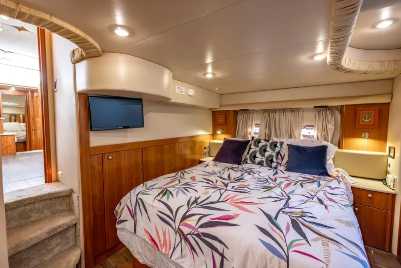 Slide: The Image of Luxurious bedroom interior of 2004 Meridian 459 Motoryacht with cozy bedding and ambient lighting. - 40