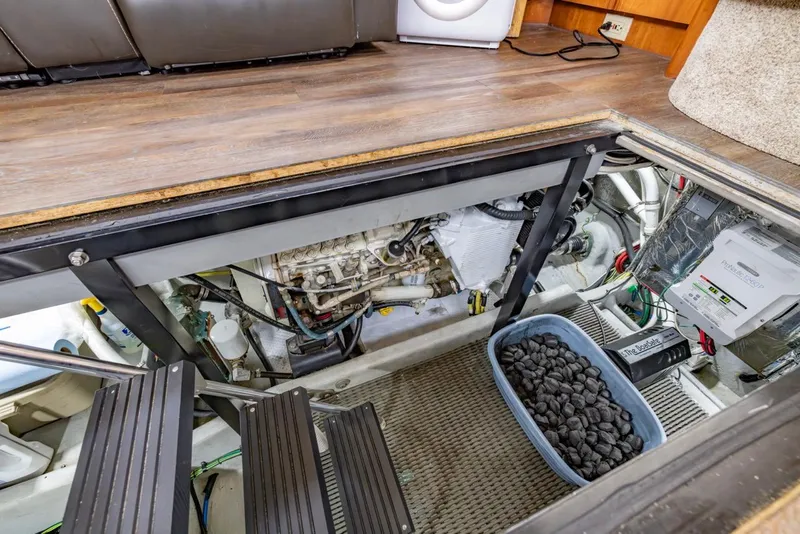 Slide: The Image of Engine room of 2004 Meridian 459 Motoryacht with visible components and maintenance supplies. - 46