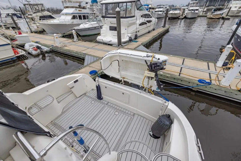 Slide: The Image of 2004 Meridian 459 Motoryacht docked at marina, showcasing spacious deck and nearby boats. - 5