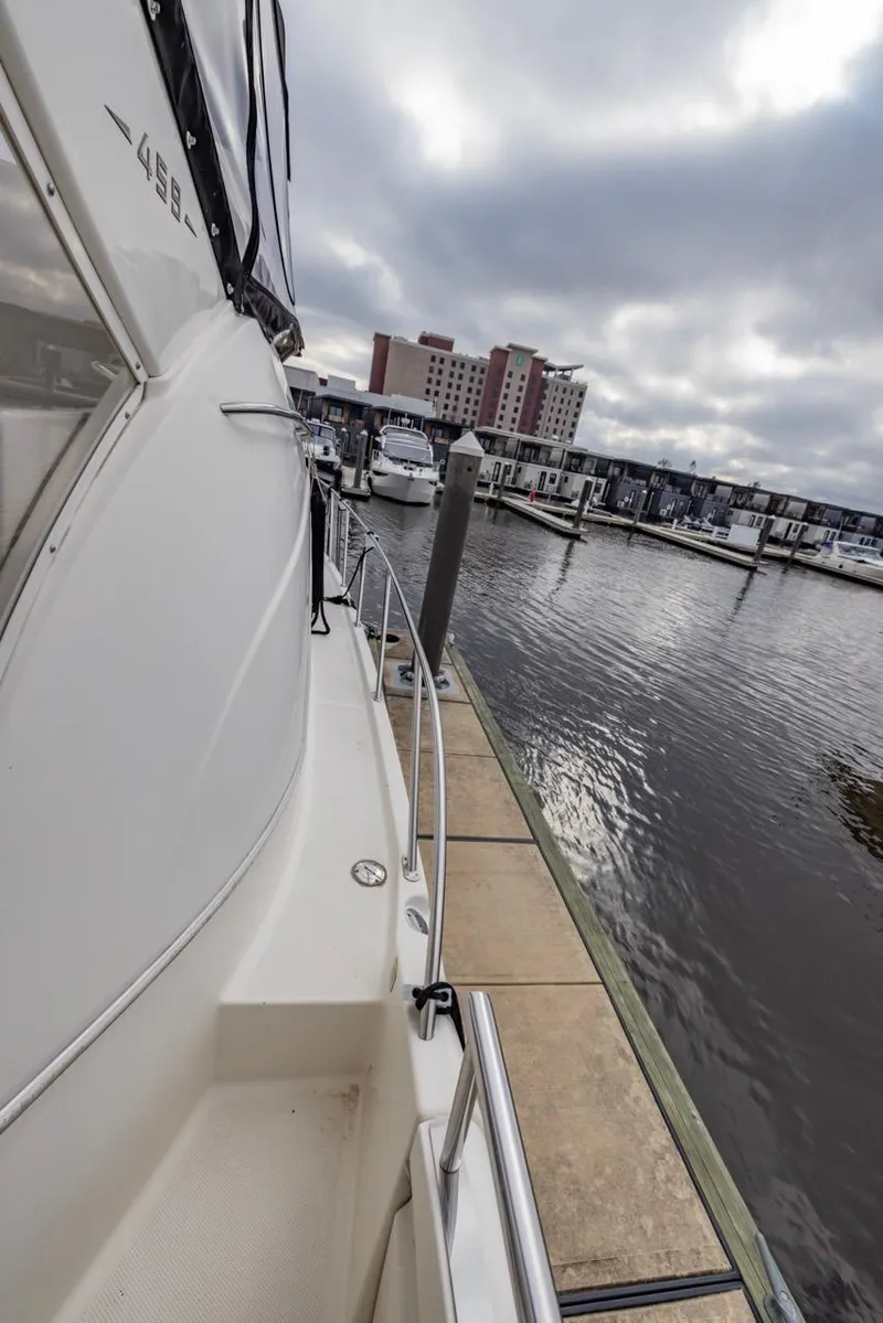 Slide: The Image of 2004 Meridian 459 Motoryacht docked at marina under cloudy skies. - 7