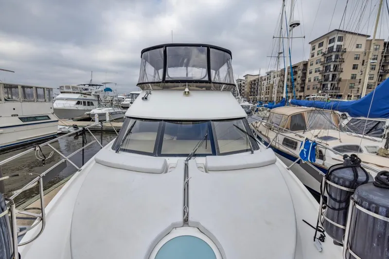 Slide: The Image of 2004 Meridian 459 Motoryacht docked in marina, surrounded by other boats and buildings. - 9