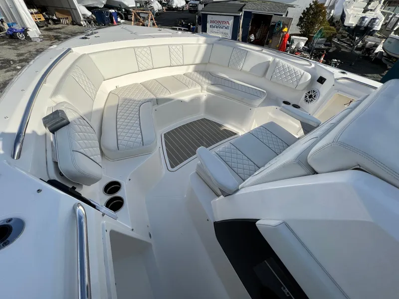 Slide: The Image of Luxurious seating area on 2022 Pursuit S 358 boat, featuring elegant white upholstery. - 13
