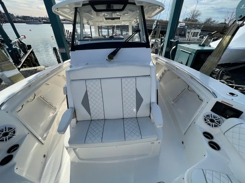 Slide: The Image of 2022 Pursuit S 358 boat interior with white seating and modern design. - 15