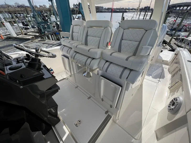 Slide: The Image of 2022 Pursuit S 358 boat interior with luxurious seating and helm controls. - 21