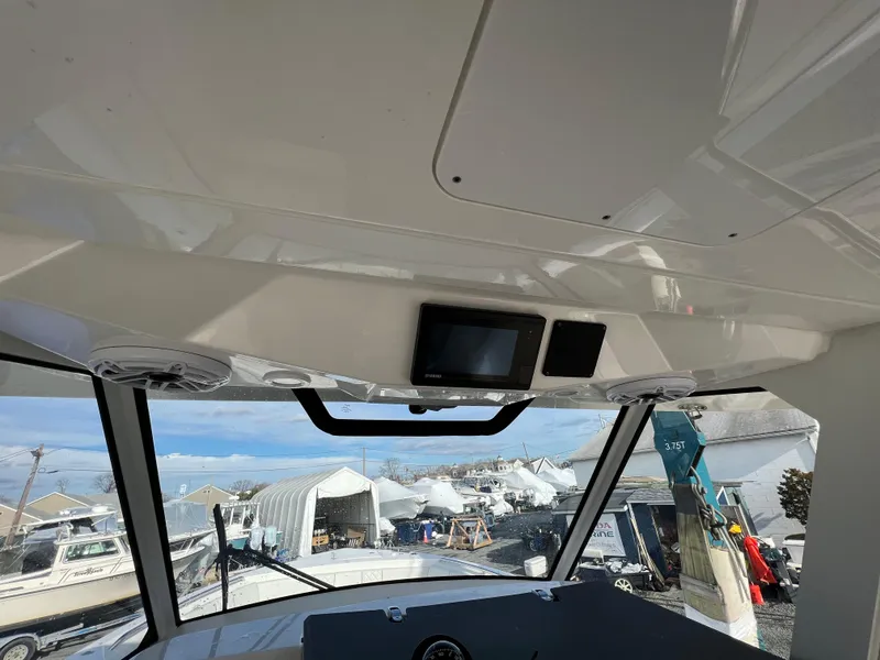 Slide: The Image of Interior view of 2022 Pursuit S 358 boat with dashboard and windows. - 24