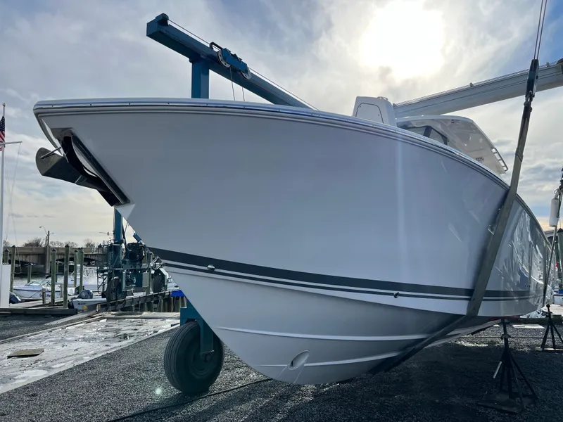 Slide: The Image of 2022 Pursuit S 358 boat on dry dock under a bright sky. - 3