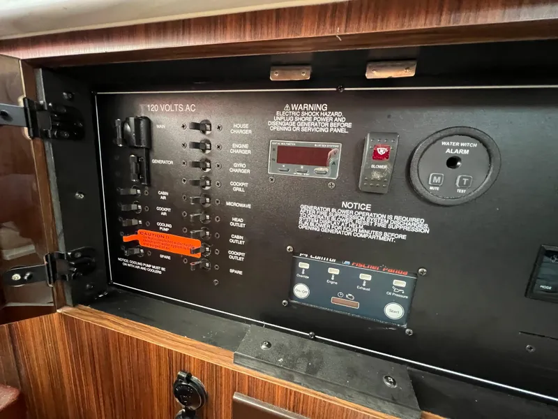 Slide: The Image of Electrical control panel of 2022 Pursuit S 358 boat, featuring switches and warning labels. - 30