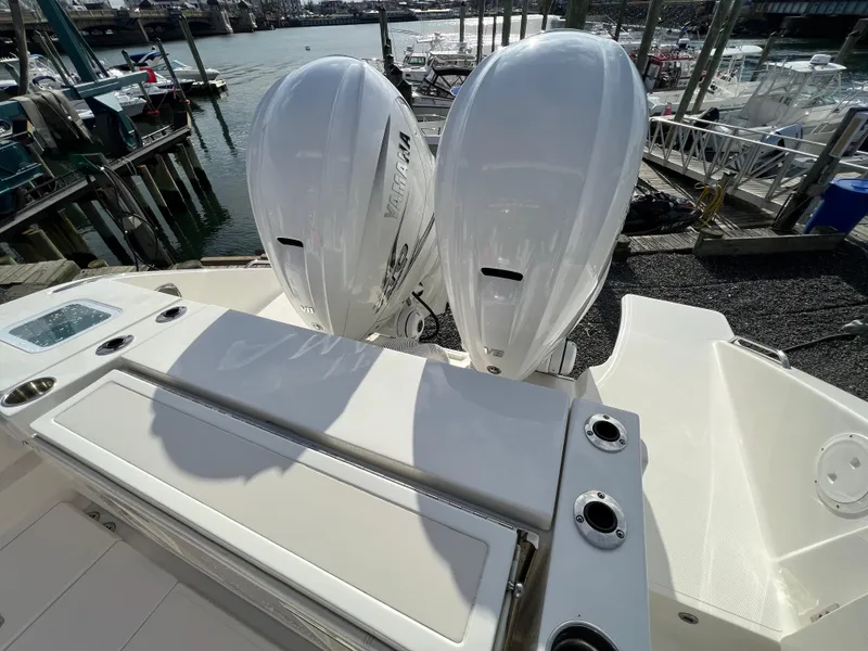 Slide: The Image of 2022 Pursuit S 358 boat with dual outboard engines at a marina. - 32