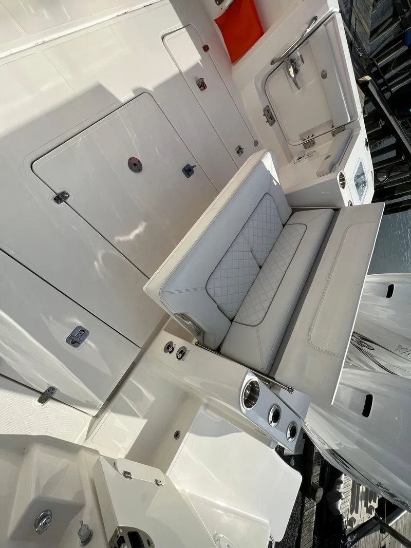 Slide: The Image of 2022 Pursuit S 358 boat interior with seating and storage compartments. - 34