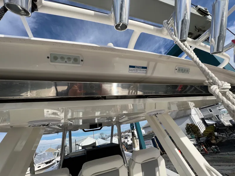 Slide: The Image of 2022 Pursuit S 358 boat interior with seating and overhead rod holders. - 37