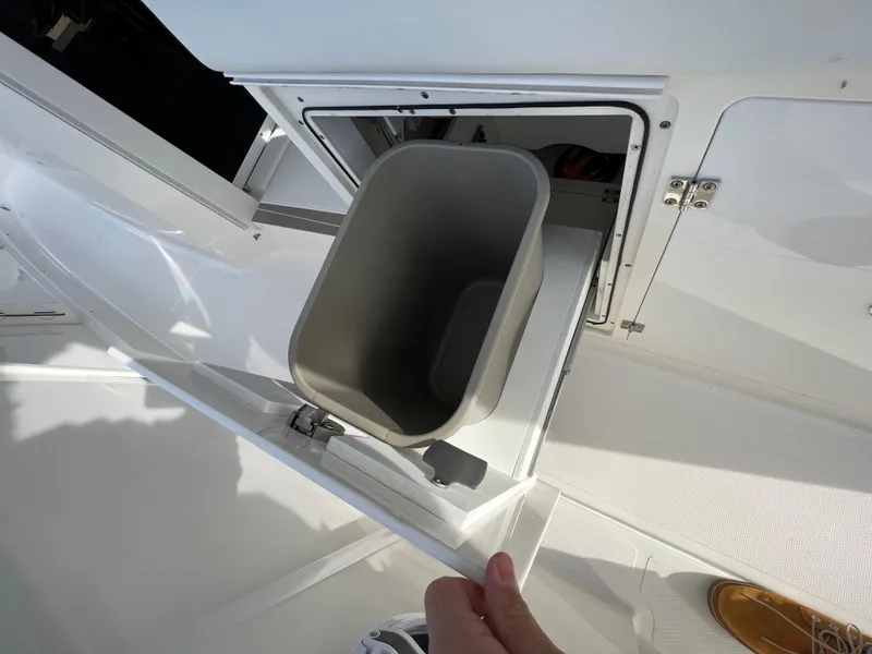 Slide: The Image of 2022 Pursuit S 358 boat with built-in storage compartment and trash bin. - 39