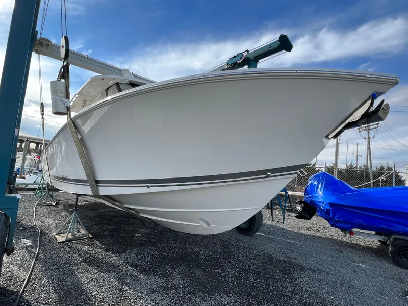 Slide: The Image of 2022 Pursuit S 358 boat on dry dock under blue sky. - 4