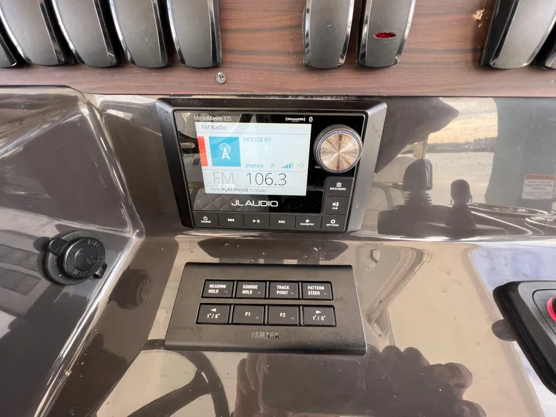 Slide: The Image of 2022 Pursuit S 358 dashboard with JL Audio system and control panel. - 43