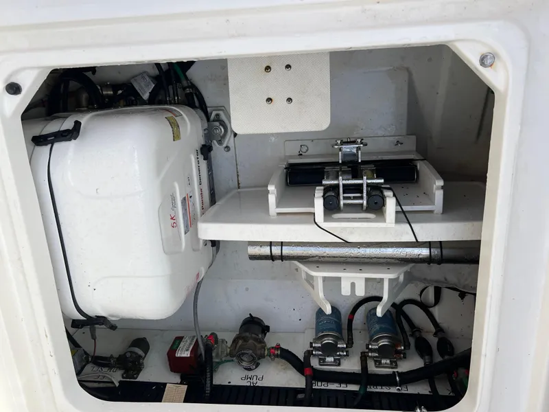 Slide: The Image of 2022 Pursuit S 358 boat engine compartment with mechanical components and wiring. - 49