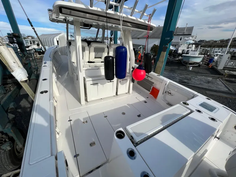 Slide: The Image of 2022 Pursuit S 358 boat interior with seating and fishing equipment. - 9