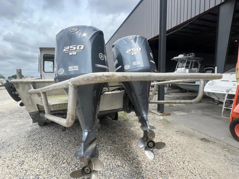 Slide: The Image of Custom Flat 28 Cabin Boat 2010 with dual 250 V6 engines in a boatyard. - 8