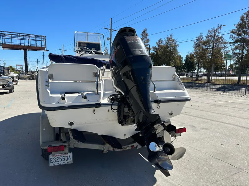 Slide: The Image of 2000 Boston Whaler Outrage 18 boat with outboard motor on trailer. - 3