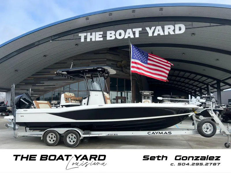 Slide: The Image of 2021 Caymas 26 HB boat on trailer at The Boat Yard, Louisiana, with American flag. - 1