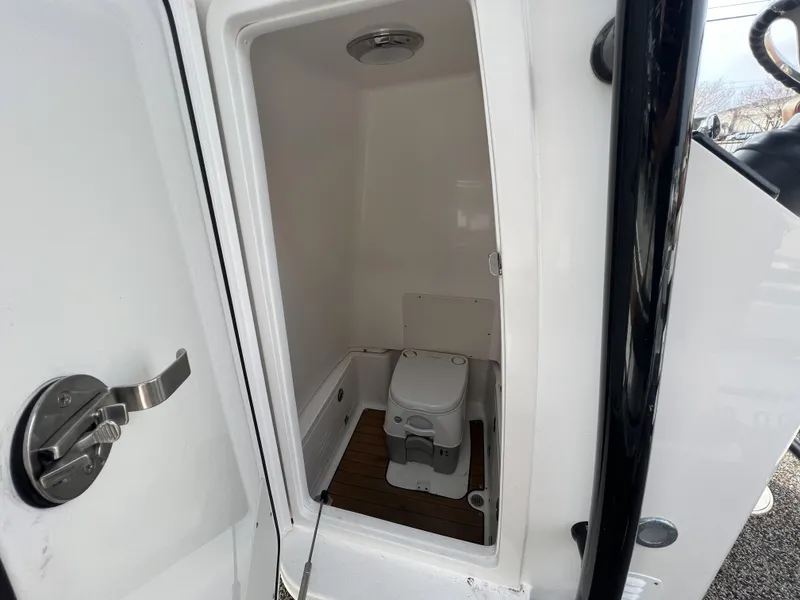 Slide: The Image of 2021 Caymas 26 HB boat interior with compact marine toilet. - 11